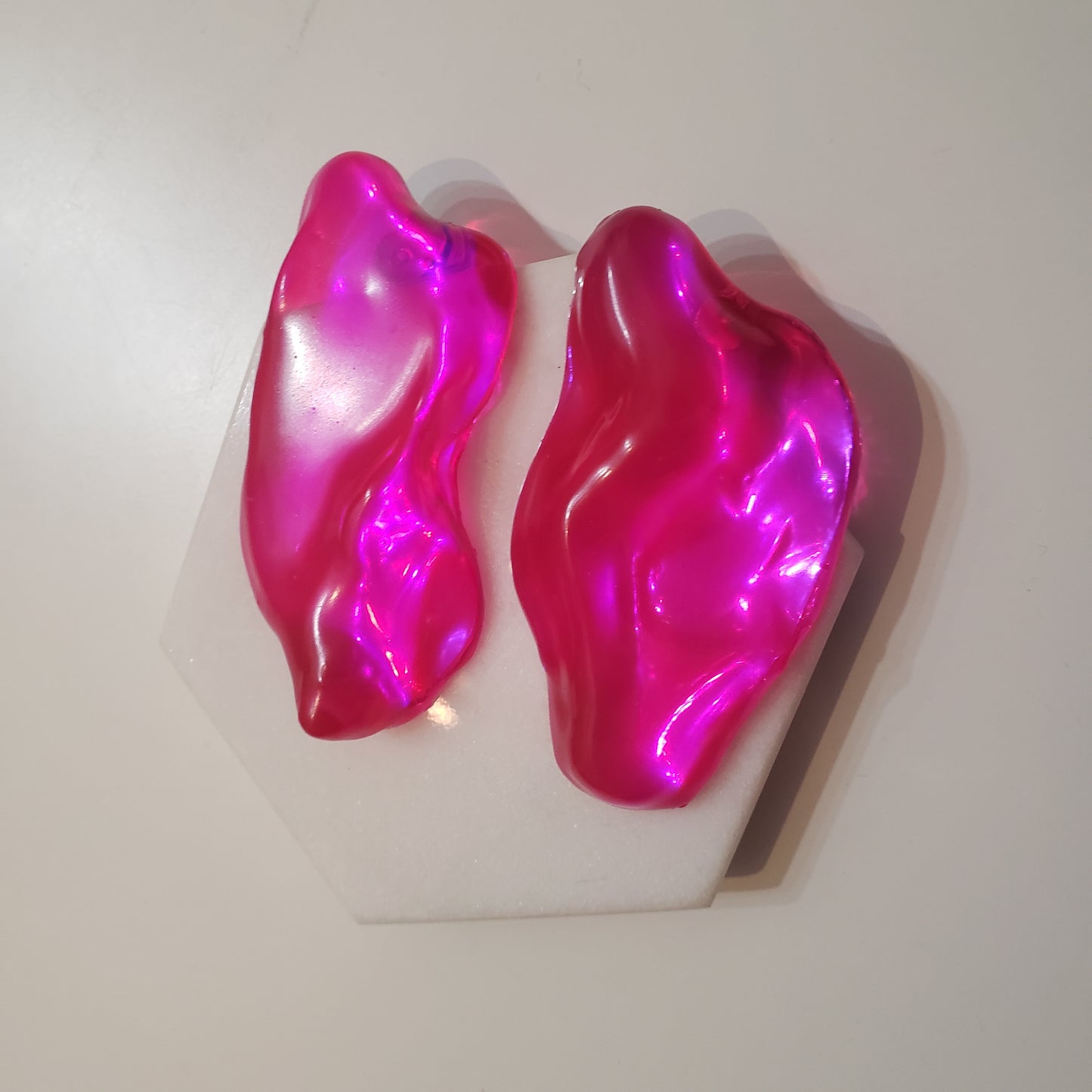 Asymmetrical Resin Earrings. Lightweight. Surgical Steel Post Backing. Dimensions: 1 ½ inch W x 2 ½ inches H. Designed and handmade in Brooklyn, NY.