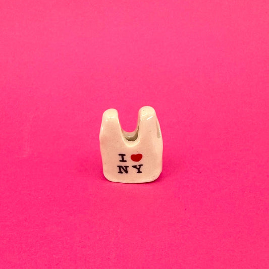 Small white bag charm with 'I ❤️ NY' text on a pink background