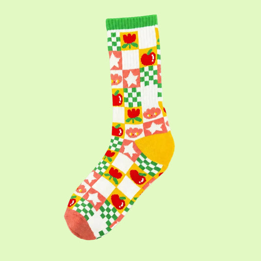 Colorful sock with checkered pattern with apples, stars, tulips, and a cartoon character.