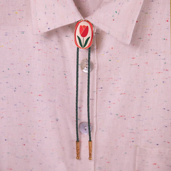 Bolo tie with a tulip design on a light pink shirt